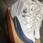 Jordan Air 12 Retro French Blue High Top White Leather Sneakers. Fixed Price $180.00.